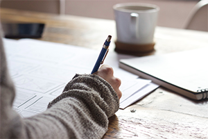 Close up photo of a hand writing notes