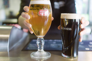 Two pints being handed over the bar at The Stags