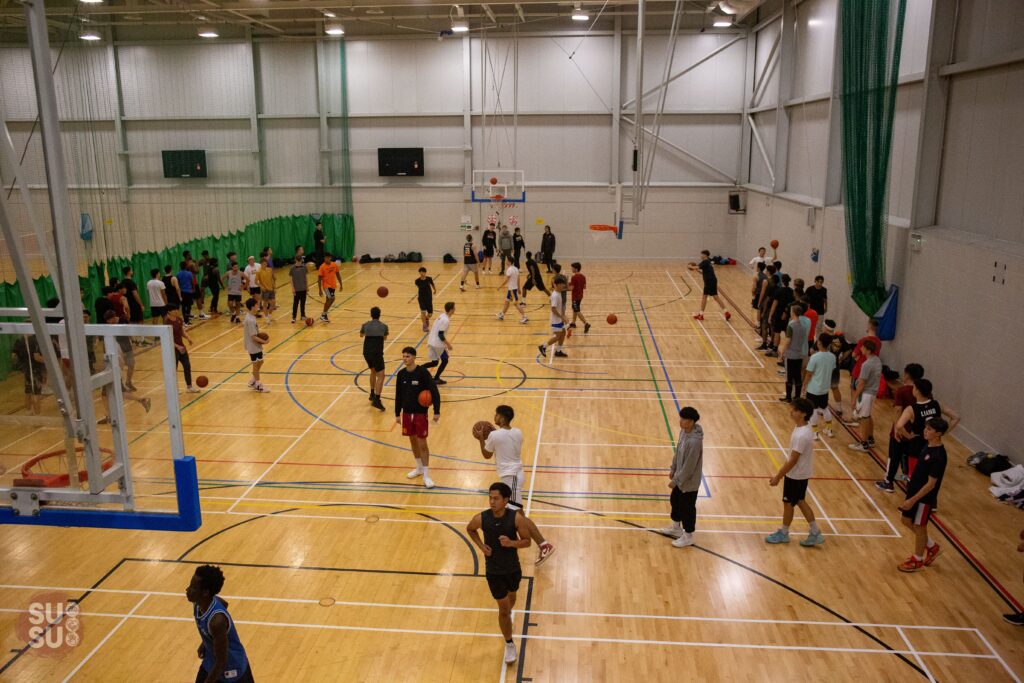 Students playing basketball in Southampton University Sports hall
