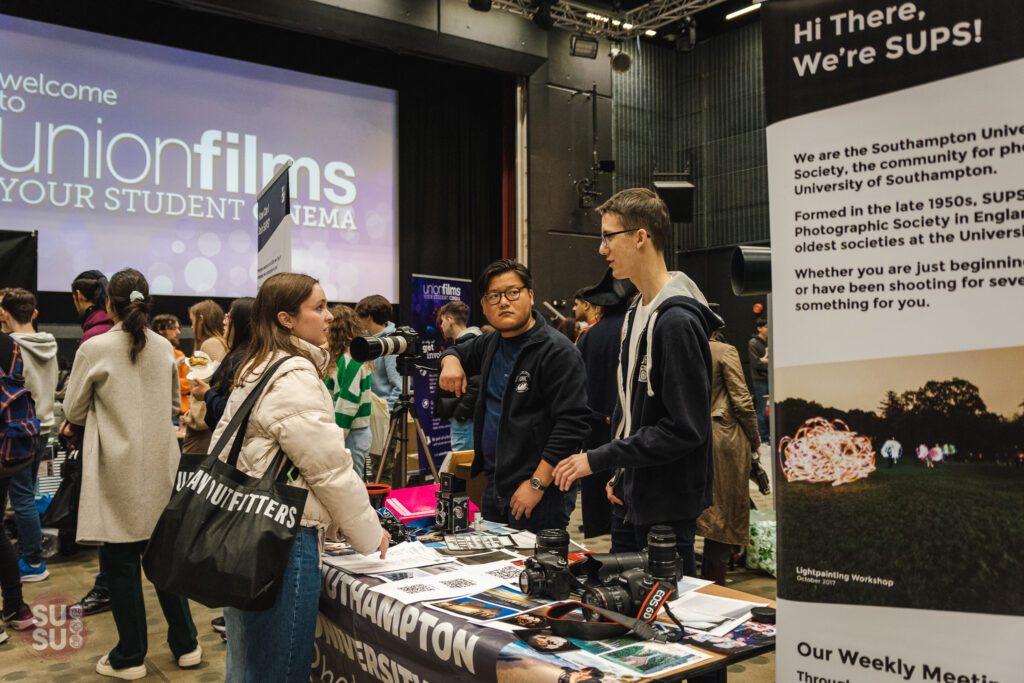 Student chatting to a Southampton University Student Union society at yearly Bunfight festival