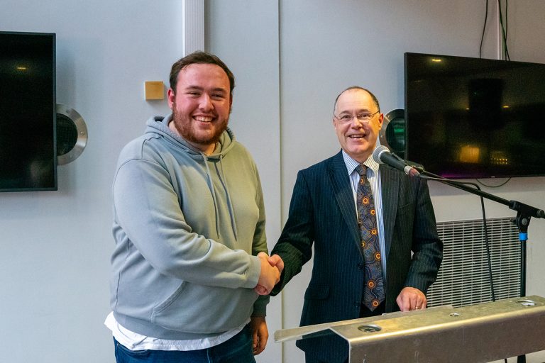 Southampton Student Union President, Ed Brooker and The University of Southampton Vice-Chancellor, Professor Mark E. Smith, shaking hands and smiling at the relationship agreement ceremony 2023