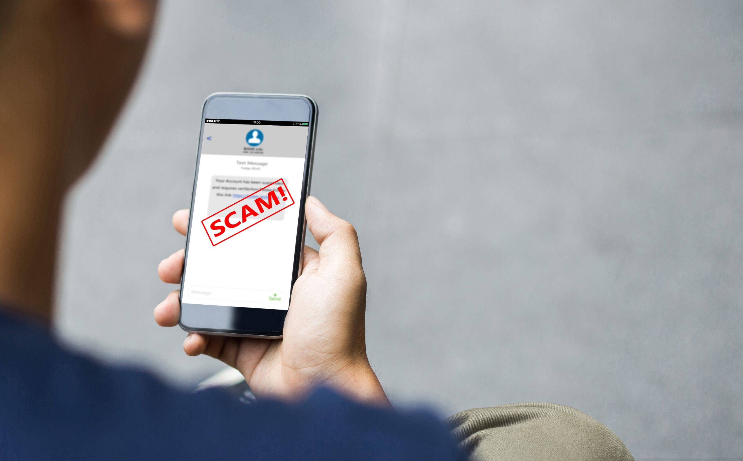 Image of a man on the phone, being warned of a scam