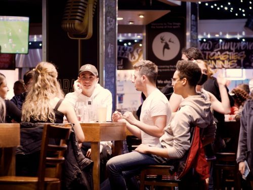 Students sitting and chatting at a table in stags